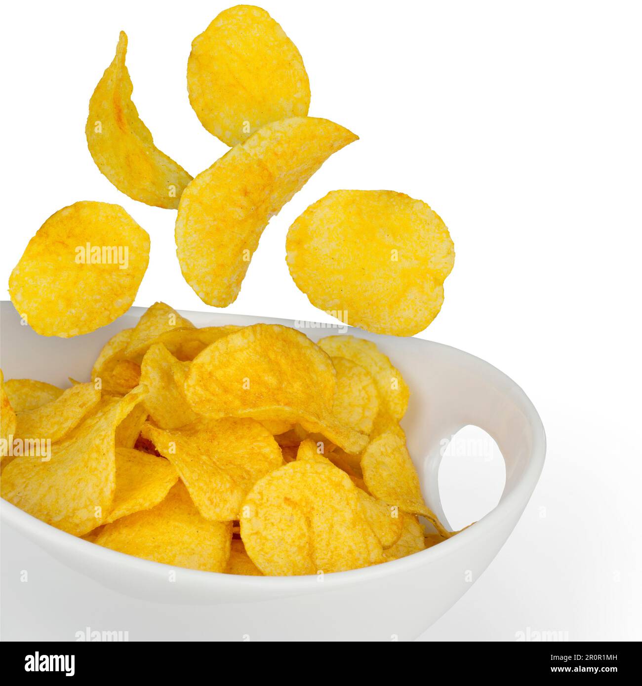 Potato chips falling in a bowl isolated Stock Photo