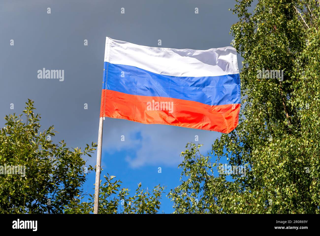 Russian state flag waving in the wind against the sky Stock Photo