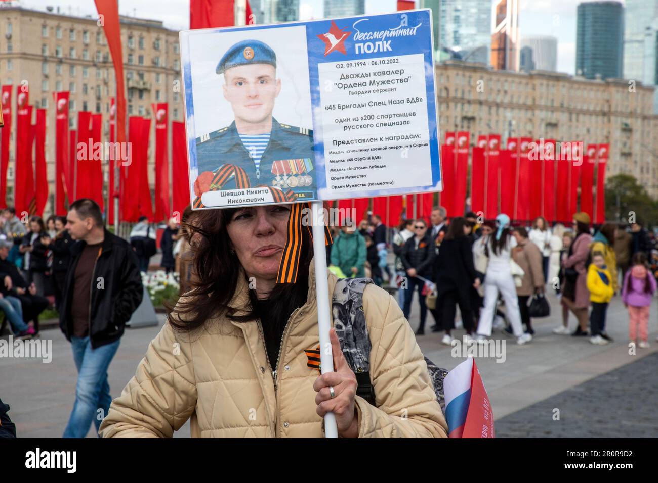 Moscow, Russia. 9th May, 2023. A woman holding a portrait of the deceased participant of a special military operation in Ukraine walks in the Victory Park during the Victory Day celebrations in Moscow, Russia. Russia celebrates the 78th anniversary of the victory over Nazi Germany during World War II. Nikolay Vinokurov/Alamy Live News Stock Photo