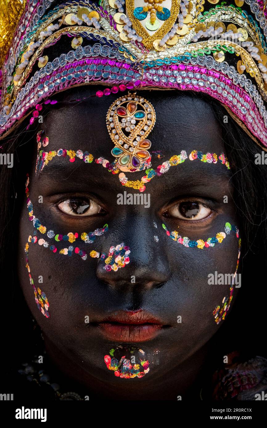A woman dressed as the Indian Goddess Kali with blue body paint cheers in  the audience at the Standon Calling Festival Stock Photo - Alamy