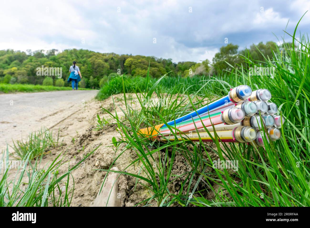 Fibre optic cable, freshly laid along a country lane, provision of fast internet in rural areas, Mülheim an der Ruhr, NRW, Germany Stock Photo