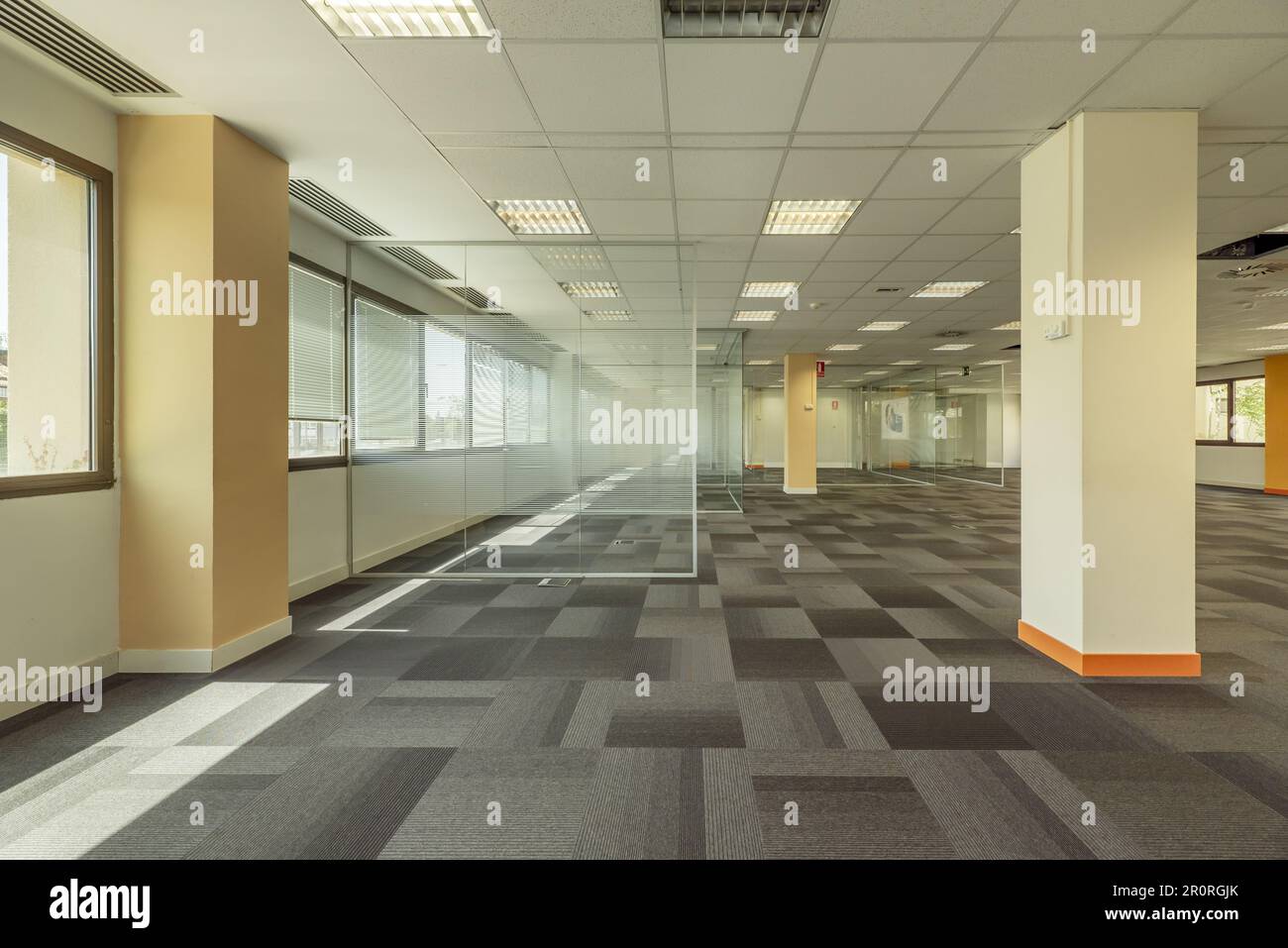 Interior of an office building with open spaces divided with tempered glass partitions Stock Photo