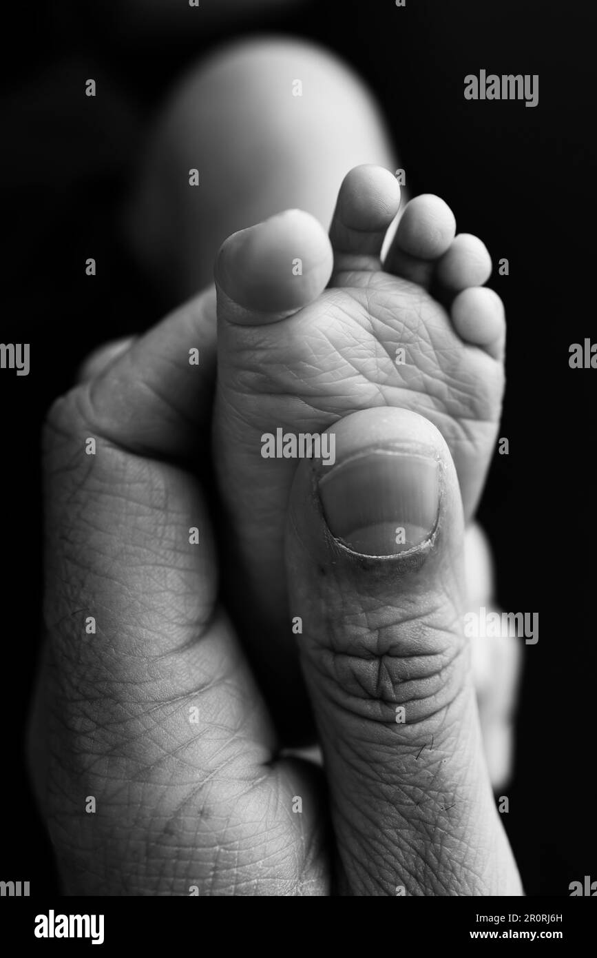 Mother is doing massage on her baby foot. Prevention of flat feet