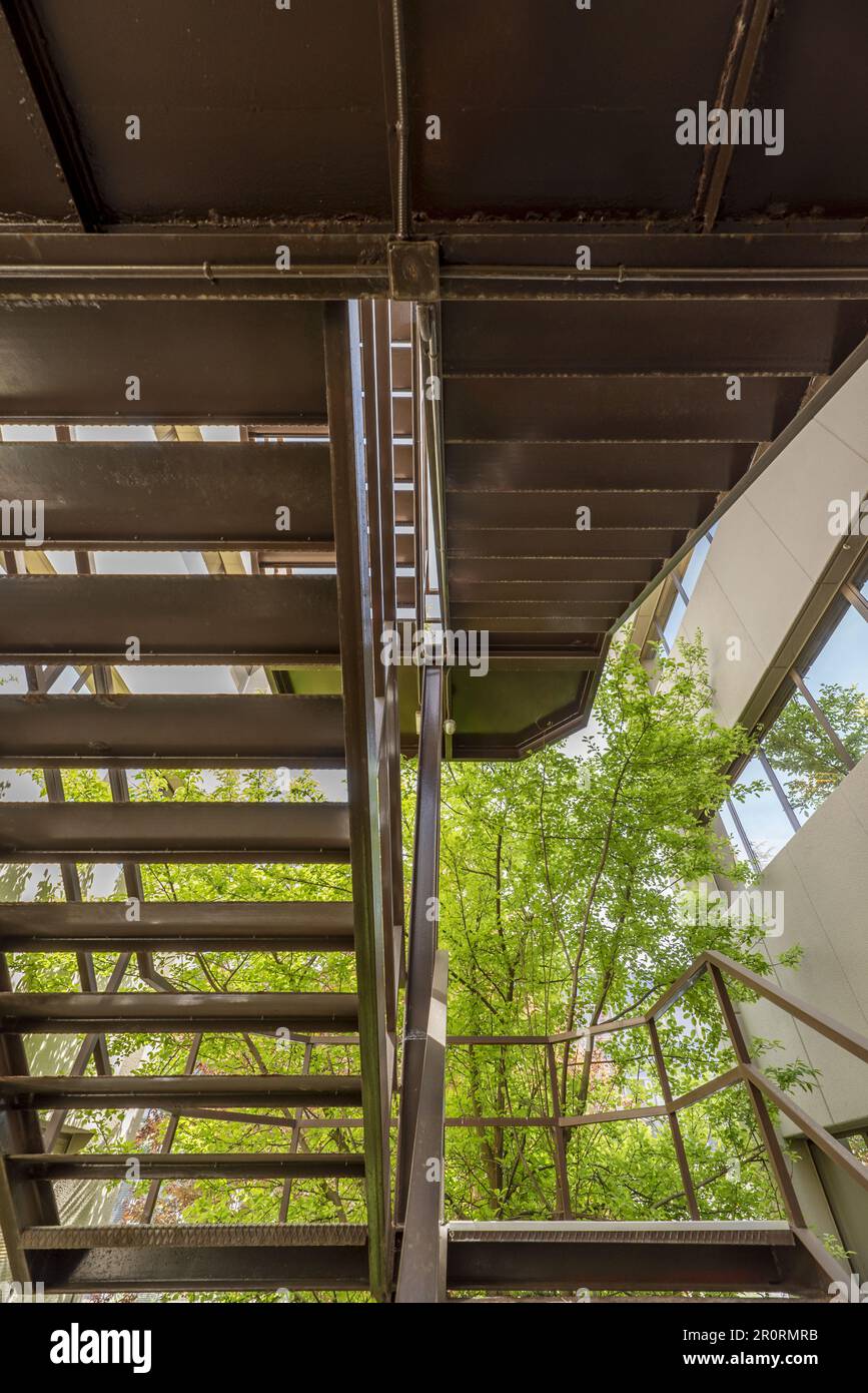 Exterior security stairs of an office building with many trees and ...