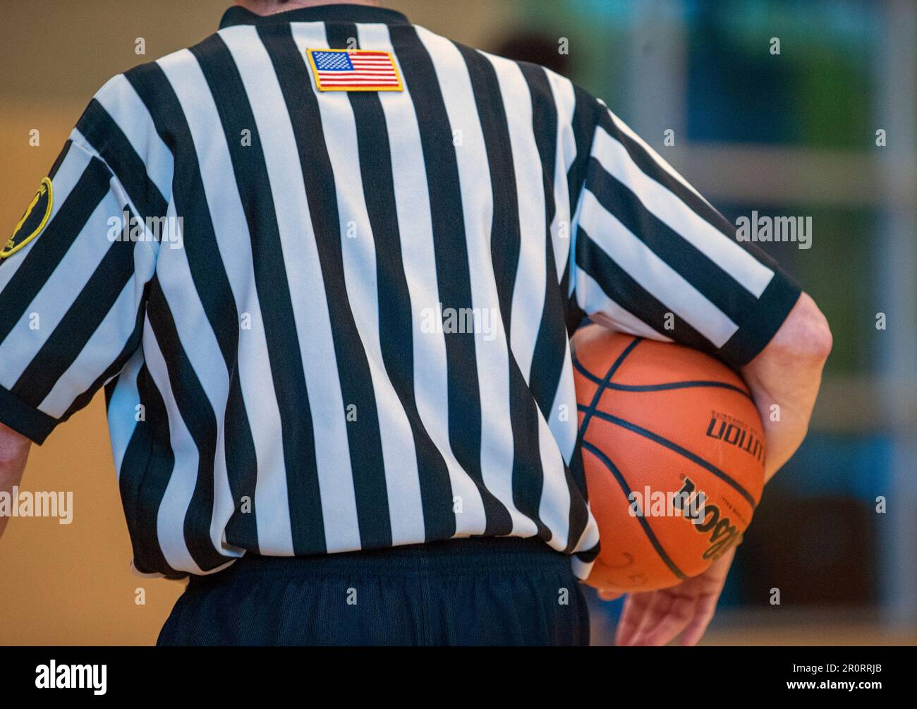 Basketball referee holding a basketball during a timeout. Stock Photo