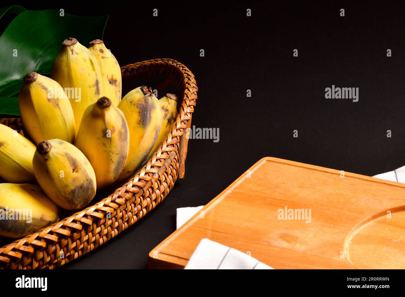 Bananas with Black background, Cultivated Banana on Black background, Thai cultivated banana.Fruits and vegetables.Copy space.Thai banana Fruit. Stock Photo