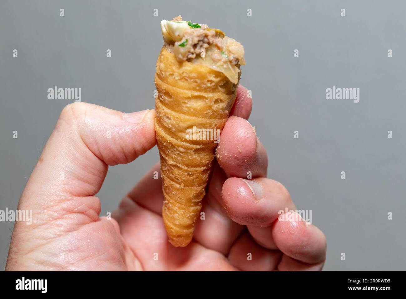 Traditional party snack known as 'canudinho'or 'tatu tail'. Stuffed with ground meat and traditional spices. Stock Photo