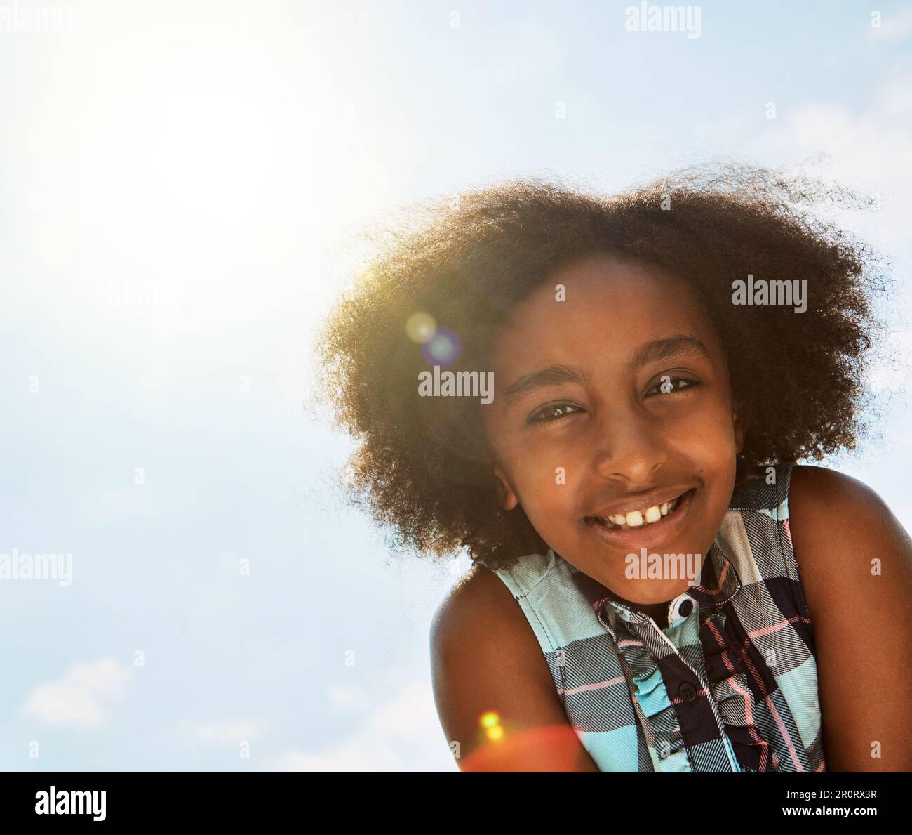 Sunny days make for sunny smiles. Portrait of a happy girl standing