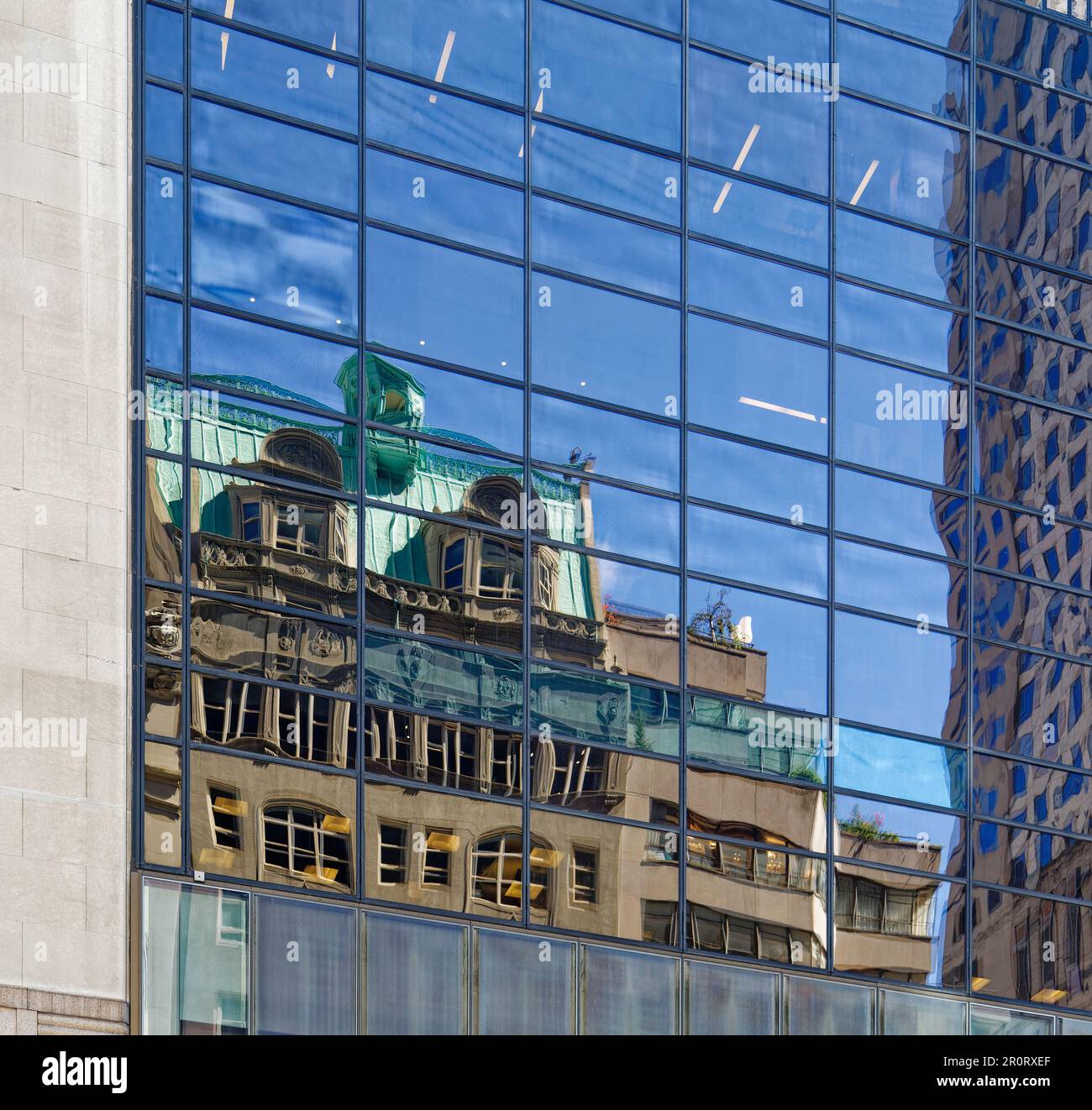 The J.M. Gidding & Company Building, reflected in Trump Tower on Fifth Avenue in Midtown Manhattan. Stock Photo