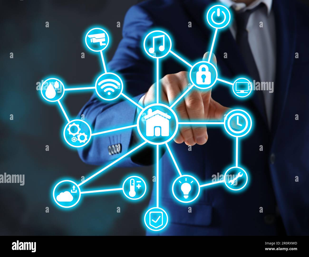 Man using digital screen with Smart Home interface on dark background, closeup Stock Photo