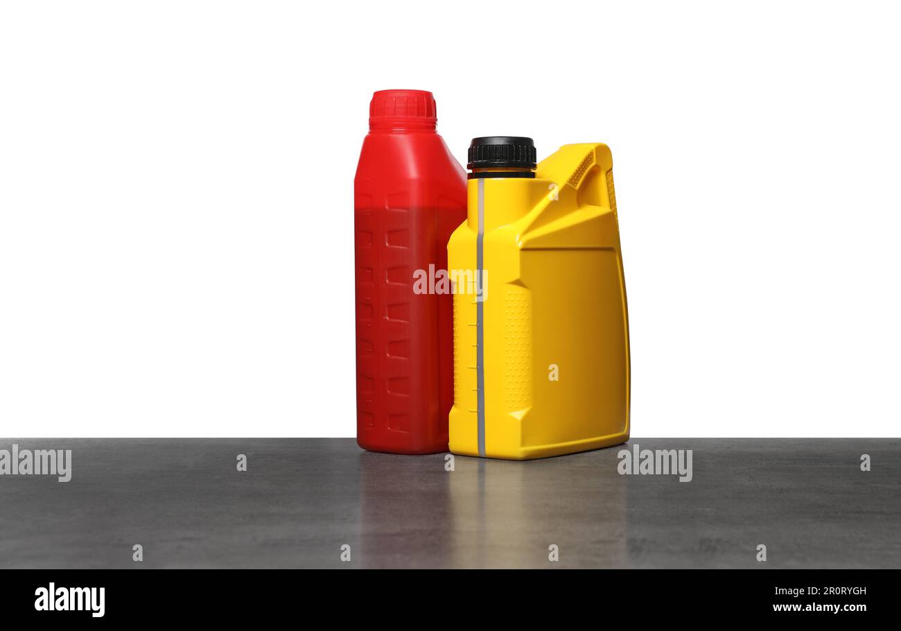 Motor Oil Container Color Motor oil in different containers on grey table against white ...