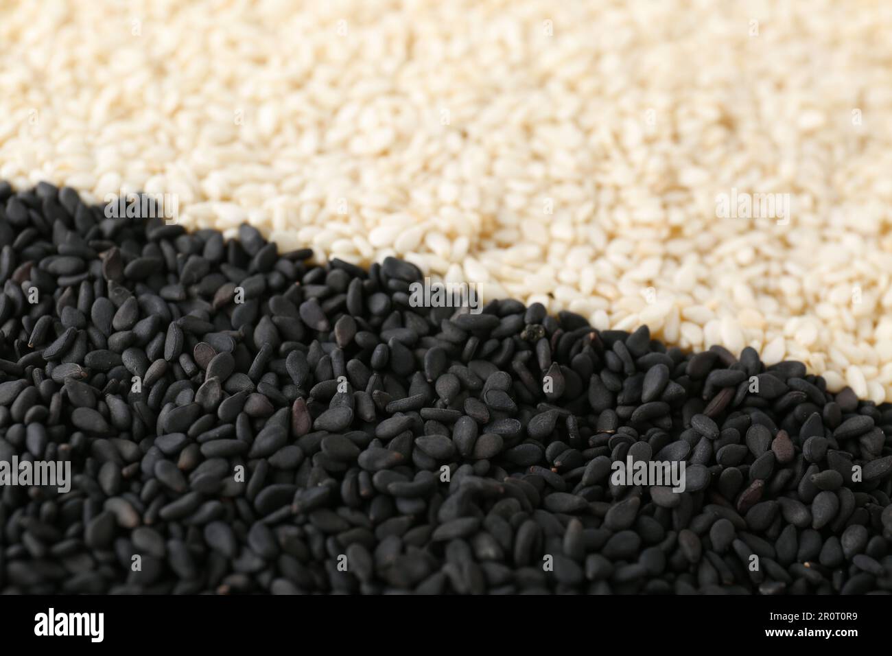 Black and white sesame seeds as background, closeup Stock Photo - Alamy