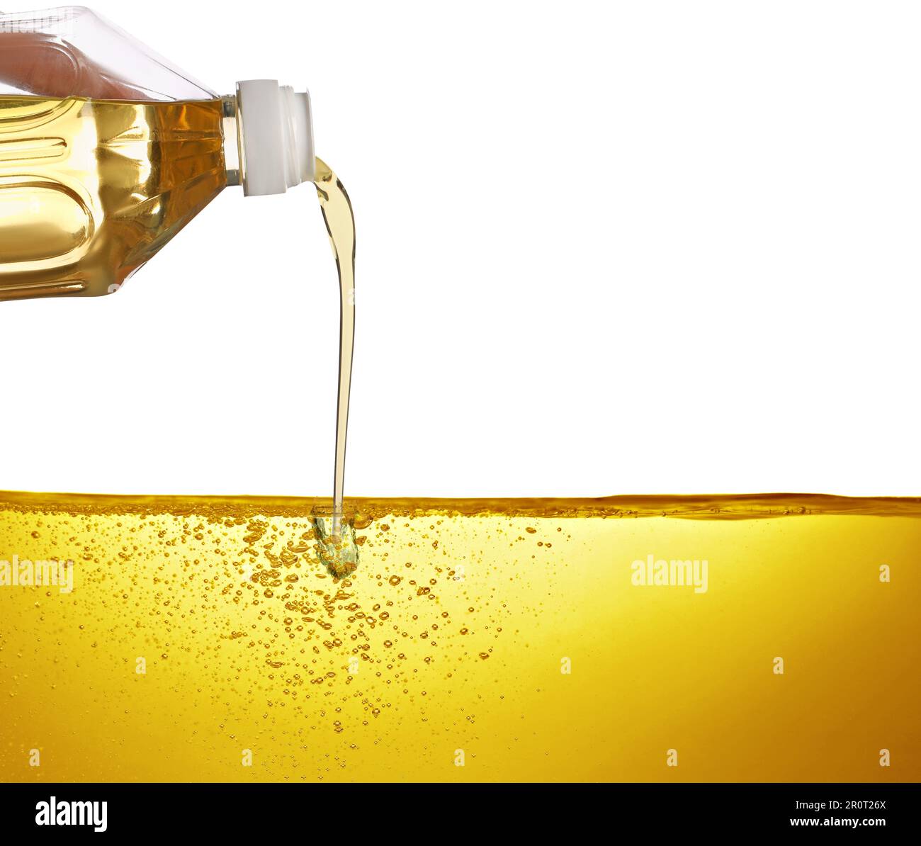 Pouring cooking oil from bottle against white background Stock Photo