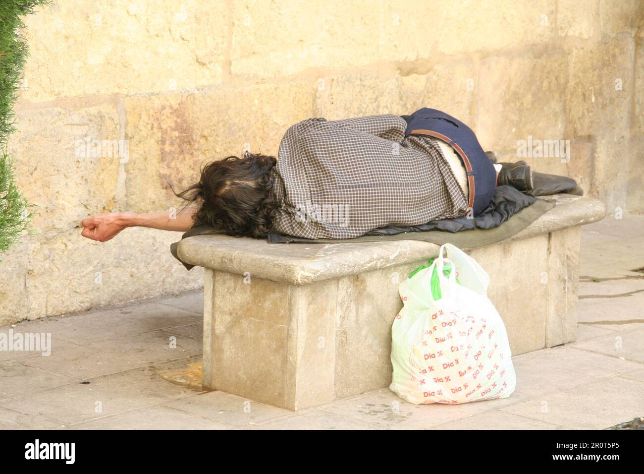 A homeless man sleeping on a bench Stock Photo - Alamy