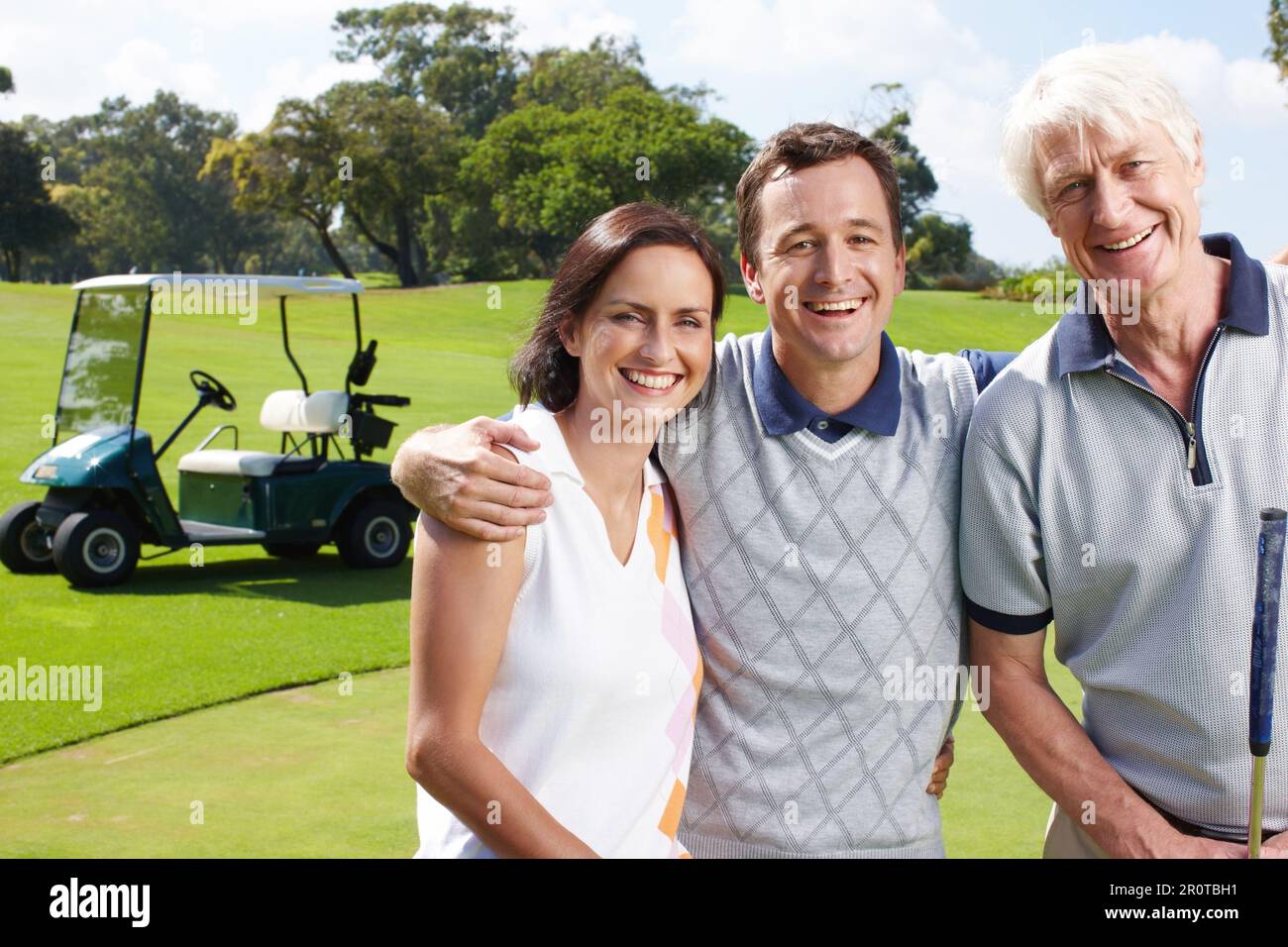 Golf is an important part of their relationship. Smiling golfing companions on the green with their golf cart in the background. Stock Photo