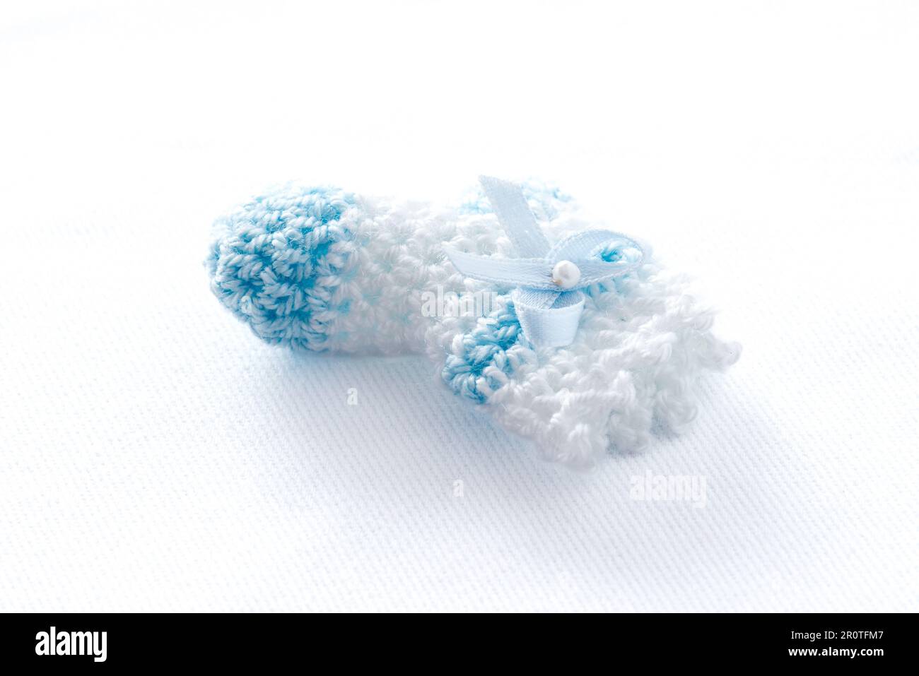 Crochet baby clothes as souvenirs for a first year birthday party Stock Photo