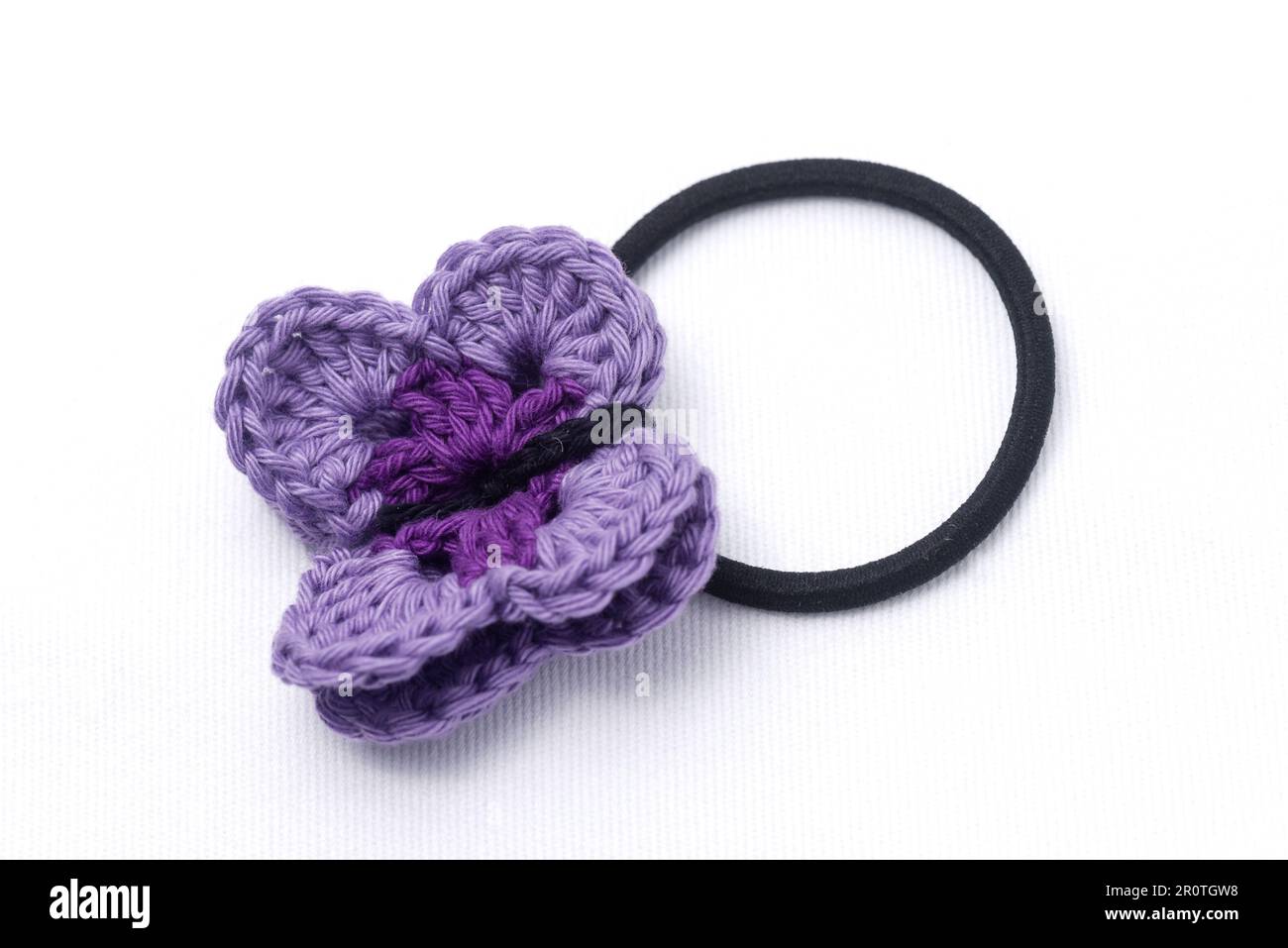 Crochet hair clips in the shape of a violet flower Stock Photo