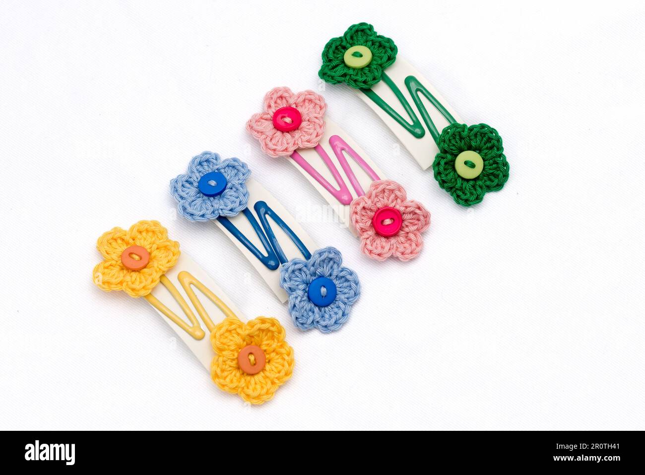 Hair clips with multicolored flowers woven with corchet Stock Photo