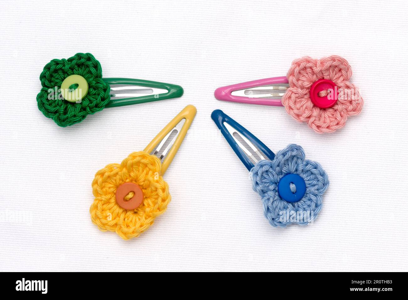 Hair clips with multicolored flowers woven with corchet Stock Photo