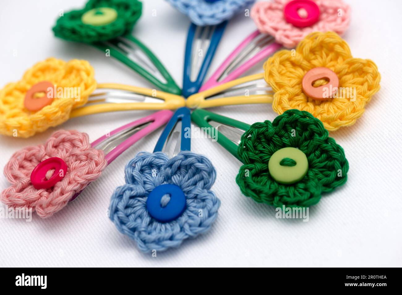 Hair clips with multicolored flowers woven with corchet Stock Photo