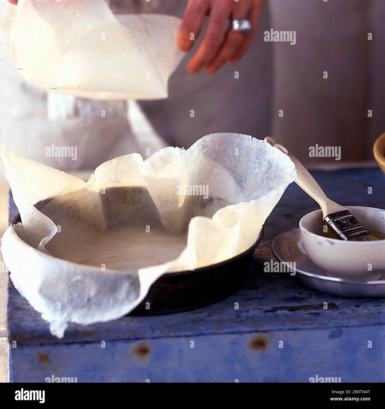 A round cake tin being lined with brick pastry Stock Photo Alamy