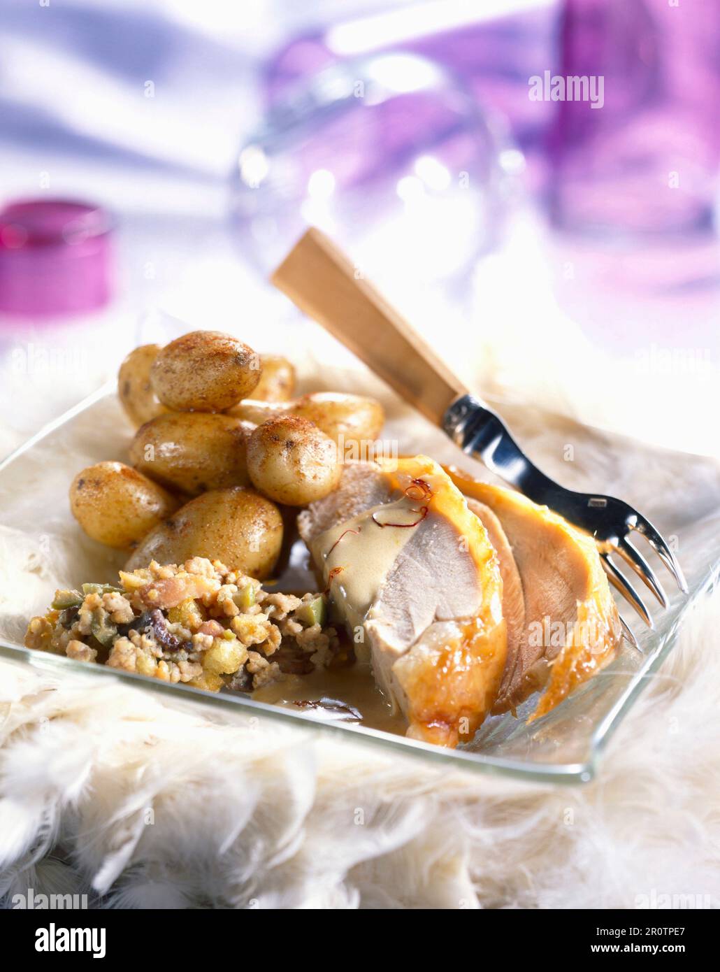 Turkey with dried fruit stuffing and potatoes, saffron sauce Stock Photo