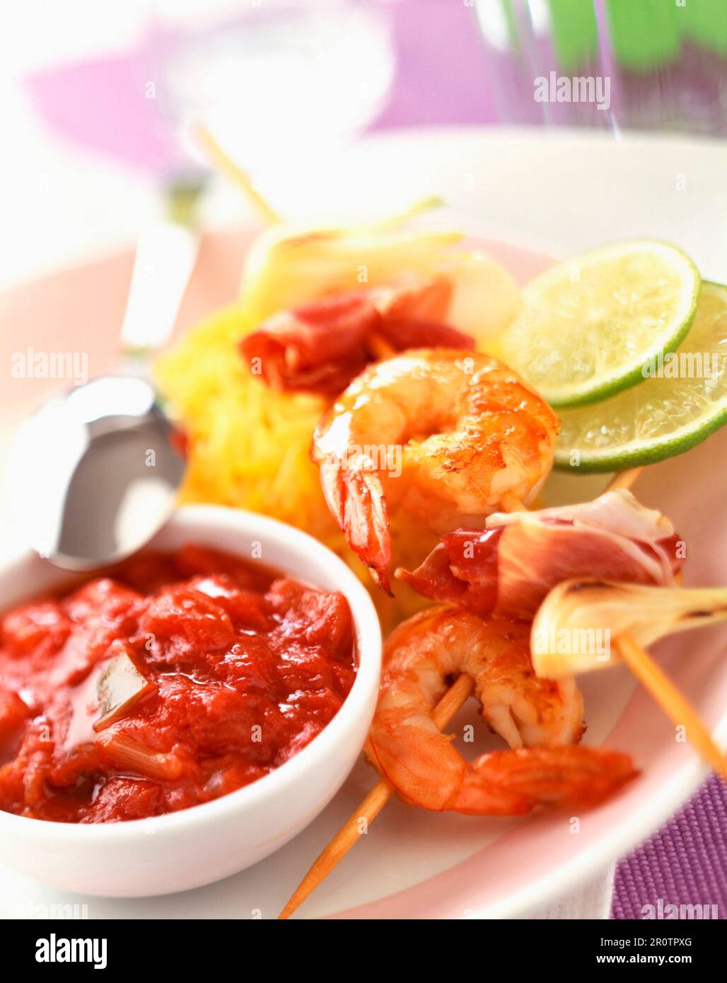 Prawn kebabs with stewed tomato sauce and saffron rice Stock Photo