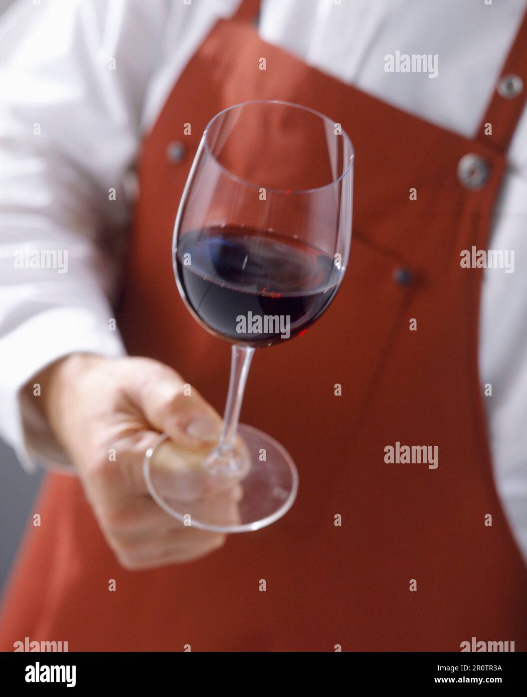 Cellarman with glass of red wine and apron Stock Photo