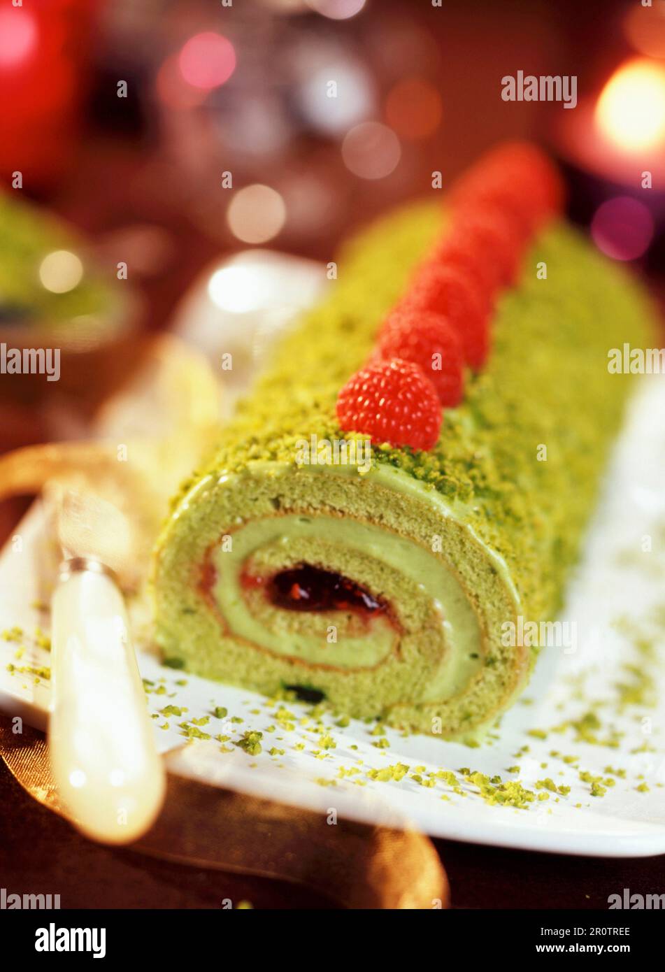 Biscuit log dessert with pistachio nuts and raspberries Stock Photo Alamy