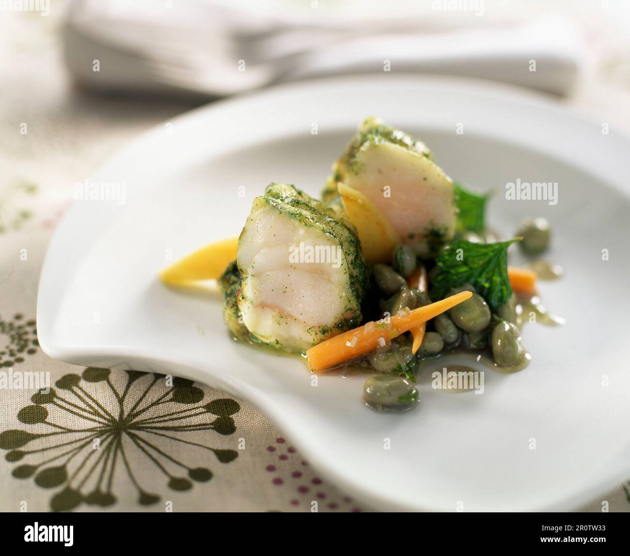 monkfish tail with mint, beans, carrots and apples Stock Photo