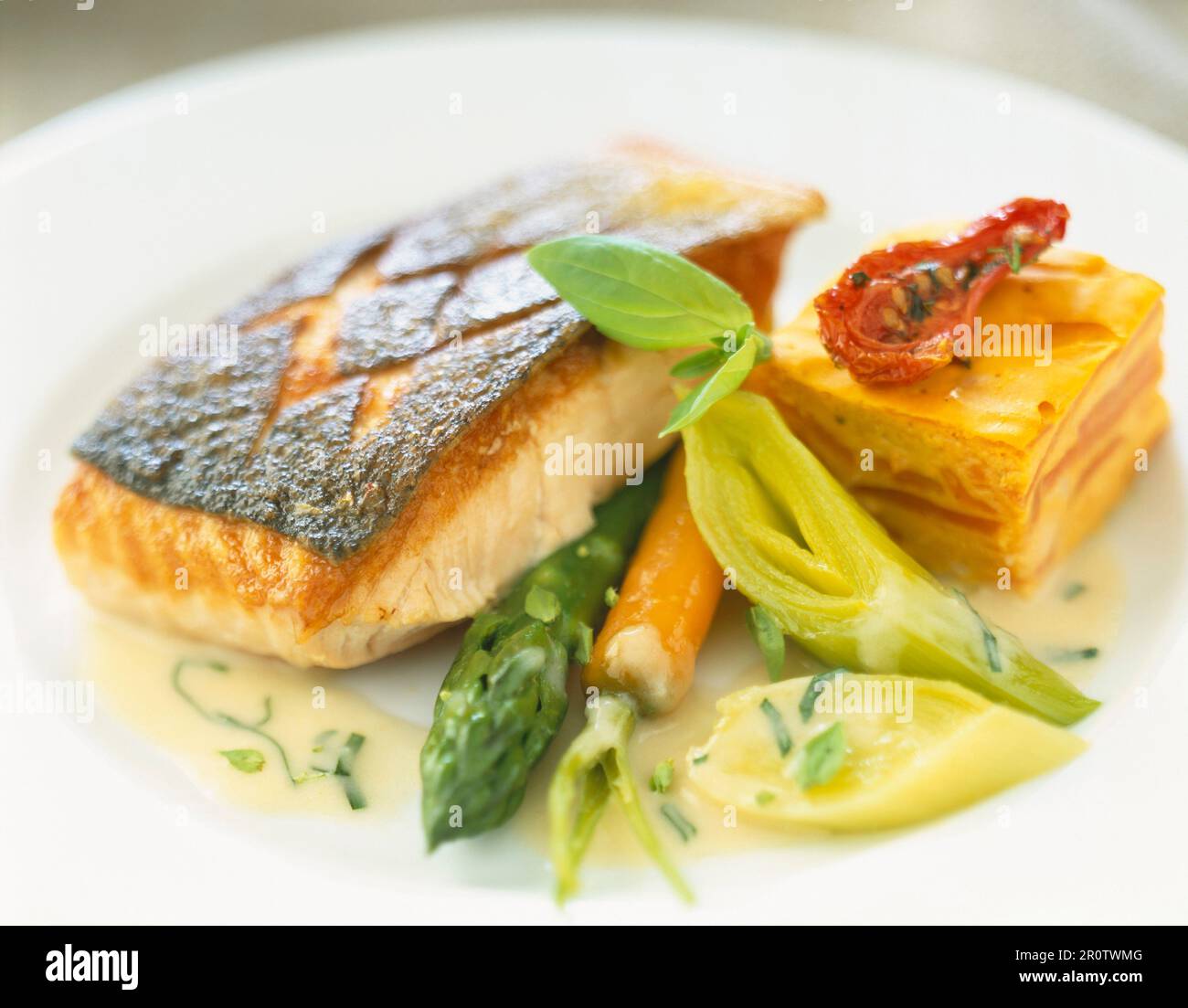 Grilled salmon steak with vegetables and carrot flan Stock Photo - Alamy