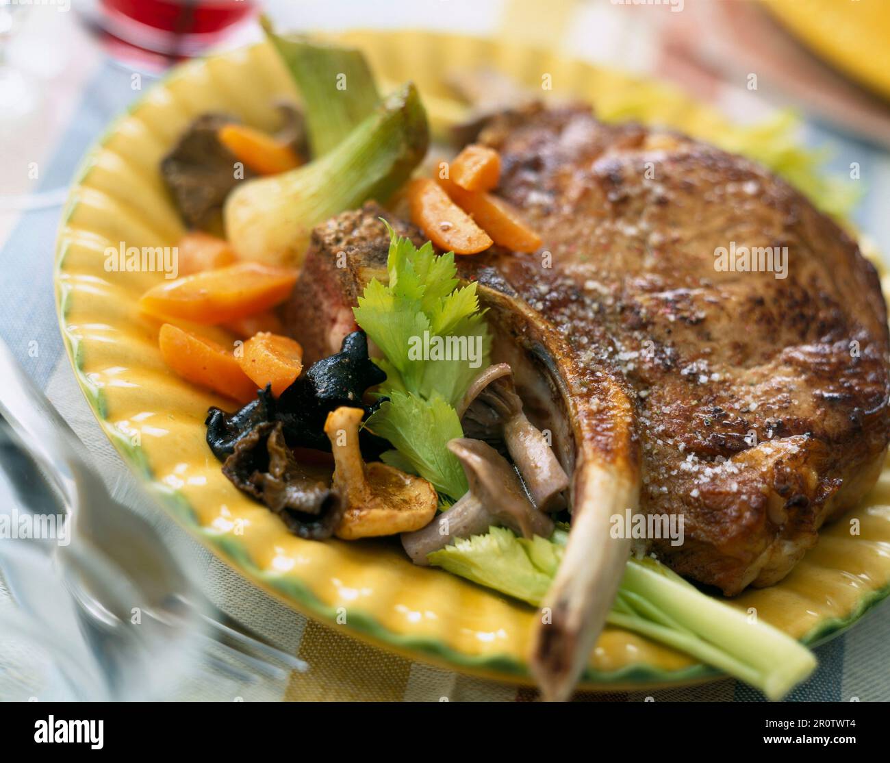 Veal chop with mushrooms, carrots and celery Stock Photo Alamy