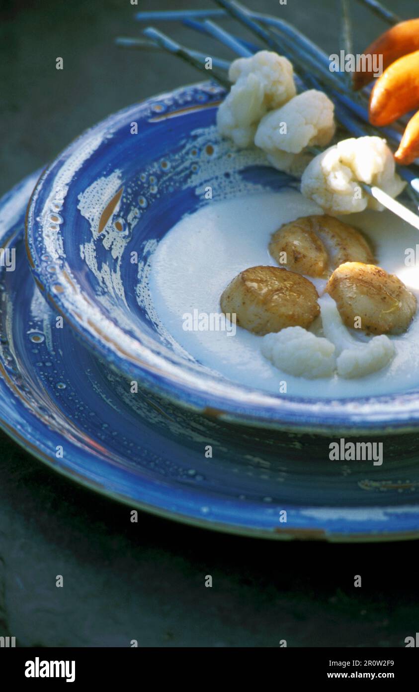 Fried scallops on cauliflower cream with a cauliflower skewer Stock Photo