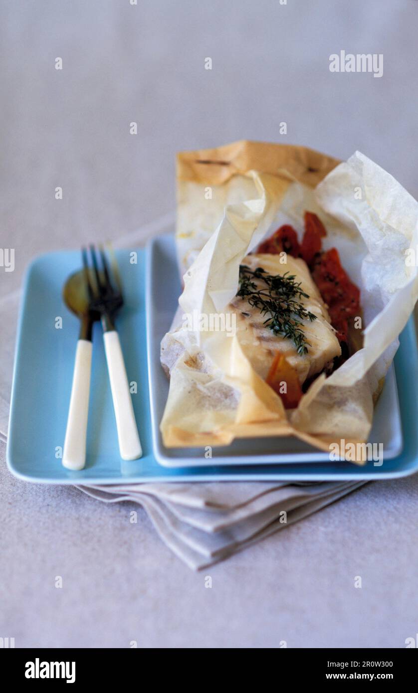 Cod in parchment paper Stock Photo