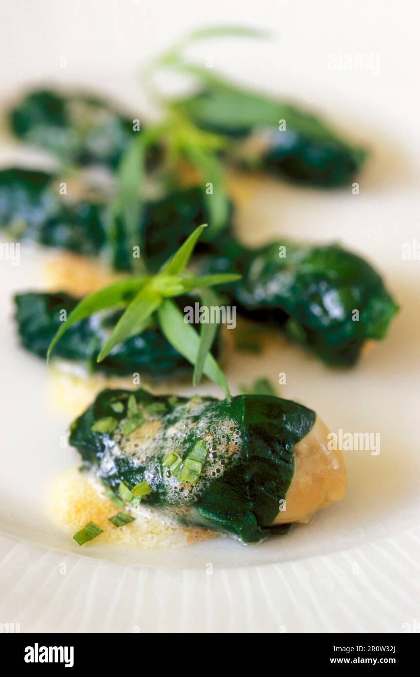 Oysters wrapped in spinach with tarragon butter Stock Photo Alamy