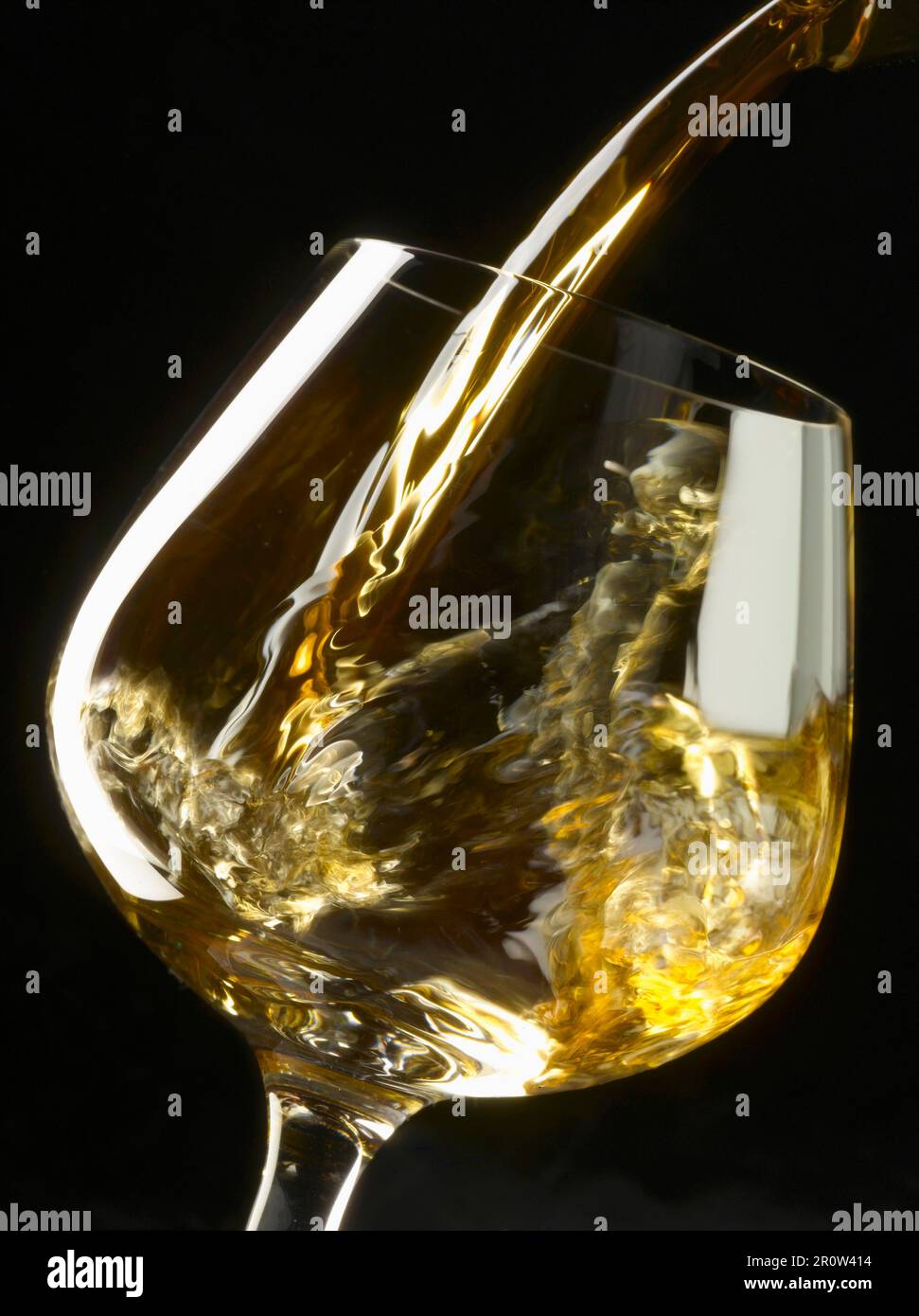 Pouring a glass of white wine Stock Photo Alamy