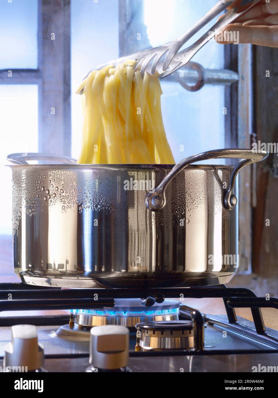 Cooking pasta in a saucepan on a gas cooker Stock Photo Alamy