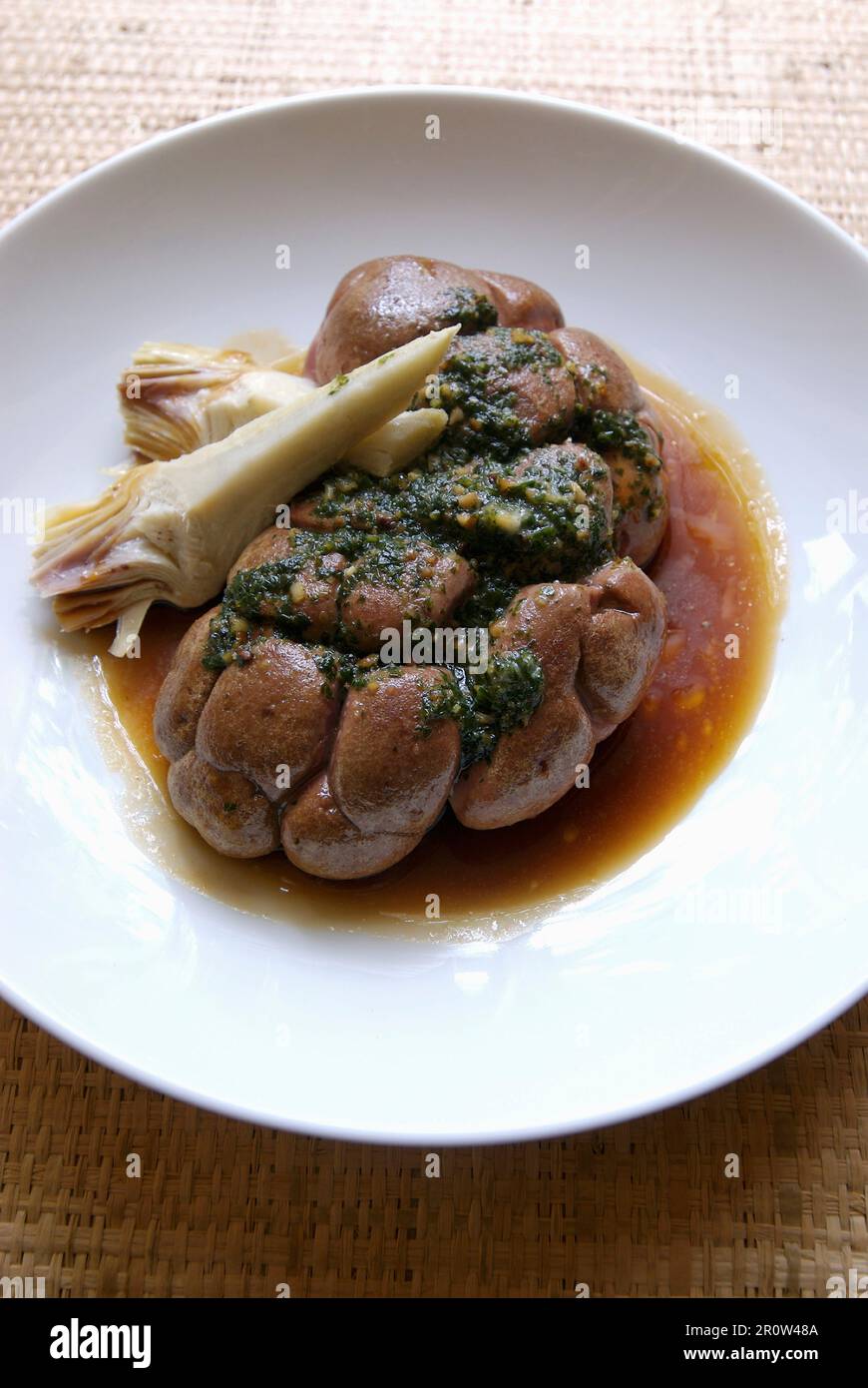 Panfried kidneys with parsley ,purple artichokes and gravy Stock Photo