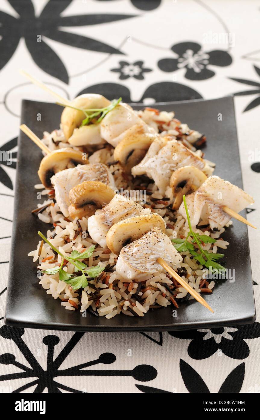 Sole and mushroom brochettes with lemon butter Stock Photo