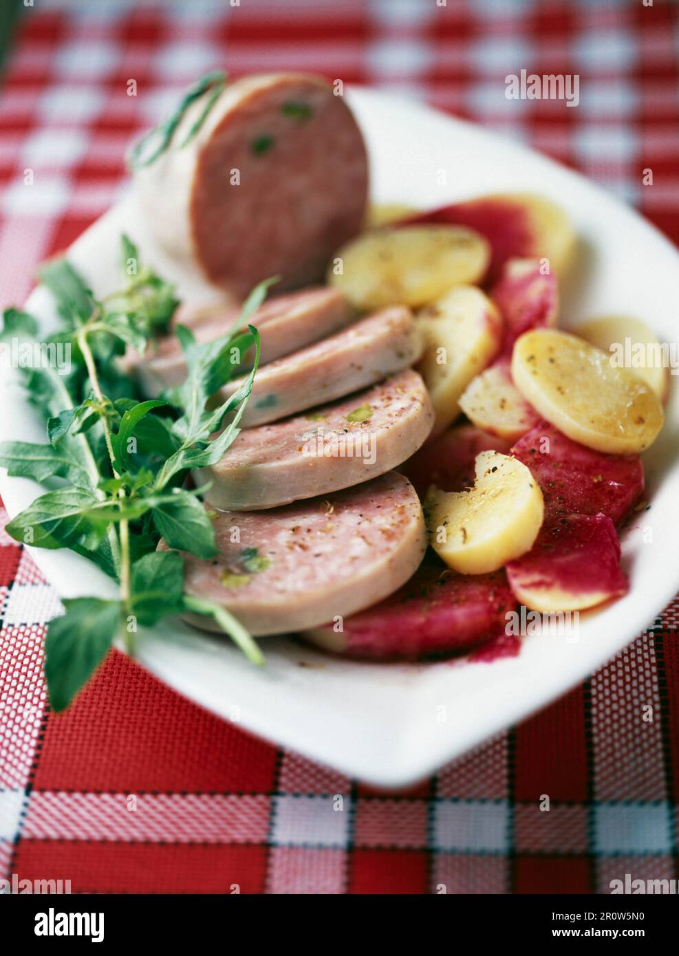 Pistachio saucisson from Lyon with potatoes and beetroot dressing Stock Photo