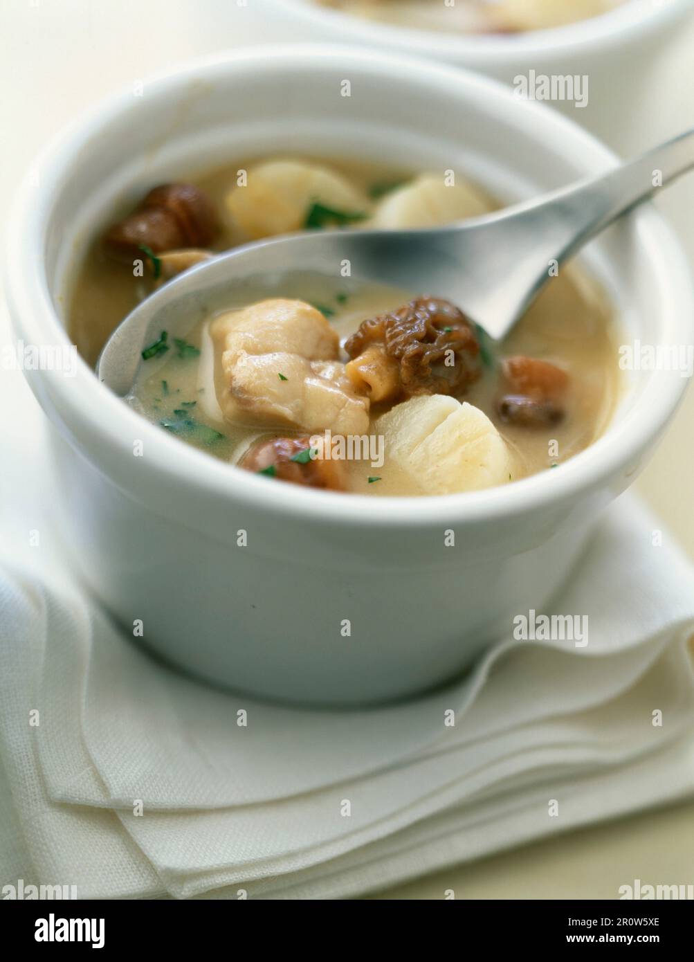 Small casserole dish of scallops and morels Stock Photo