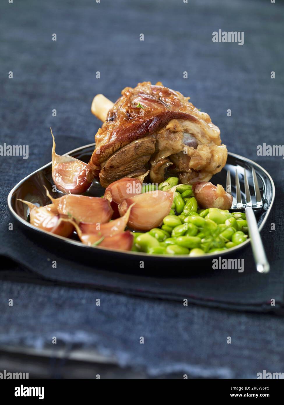 Leg of lamb with broad beans and garlic Stock Photo