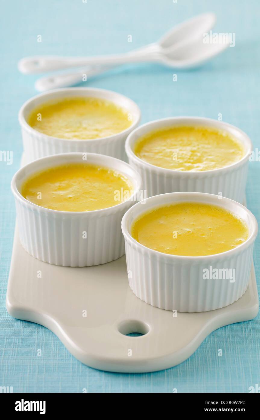 Orange blossom waterflavored baked egg custards Stock Photo Alamy