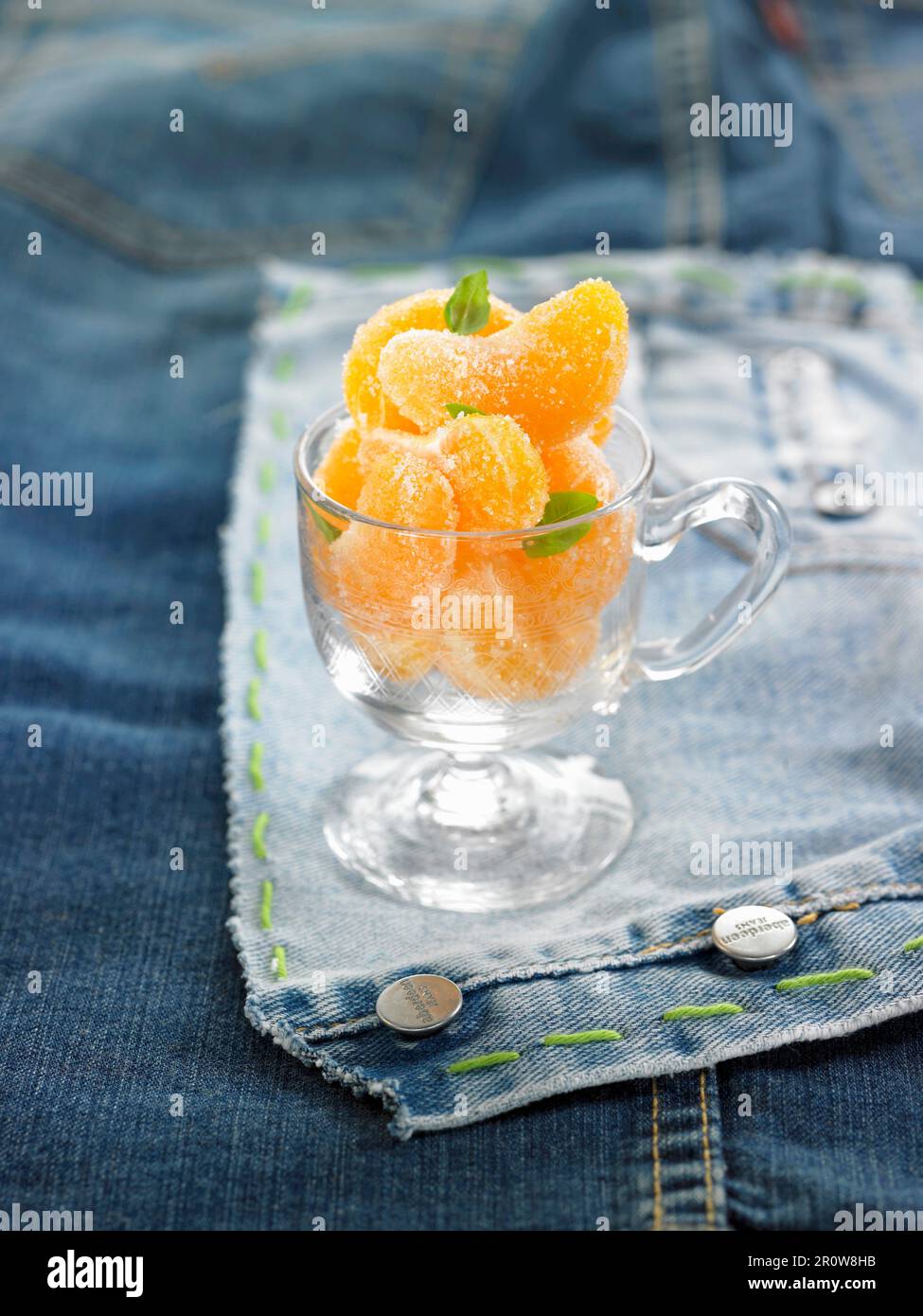 Frosted tangerine segments with basil Stock Photo