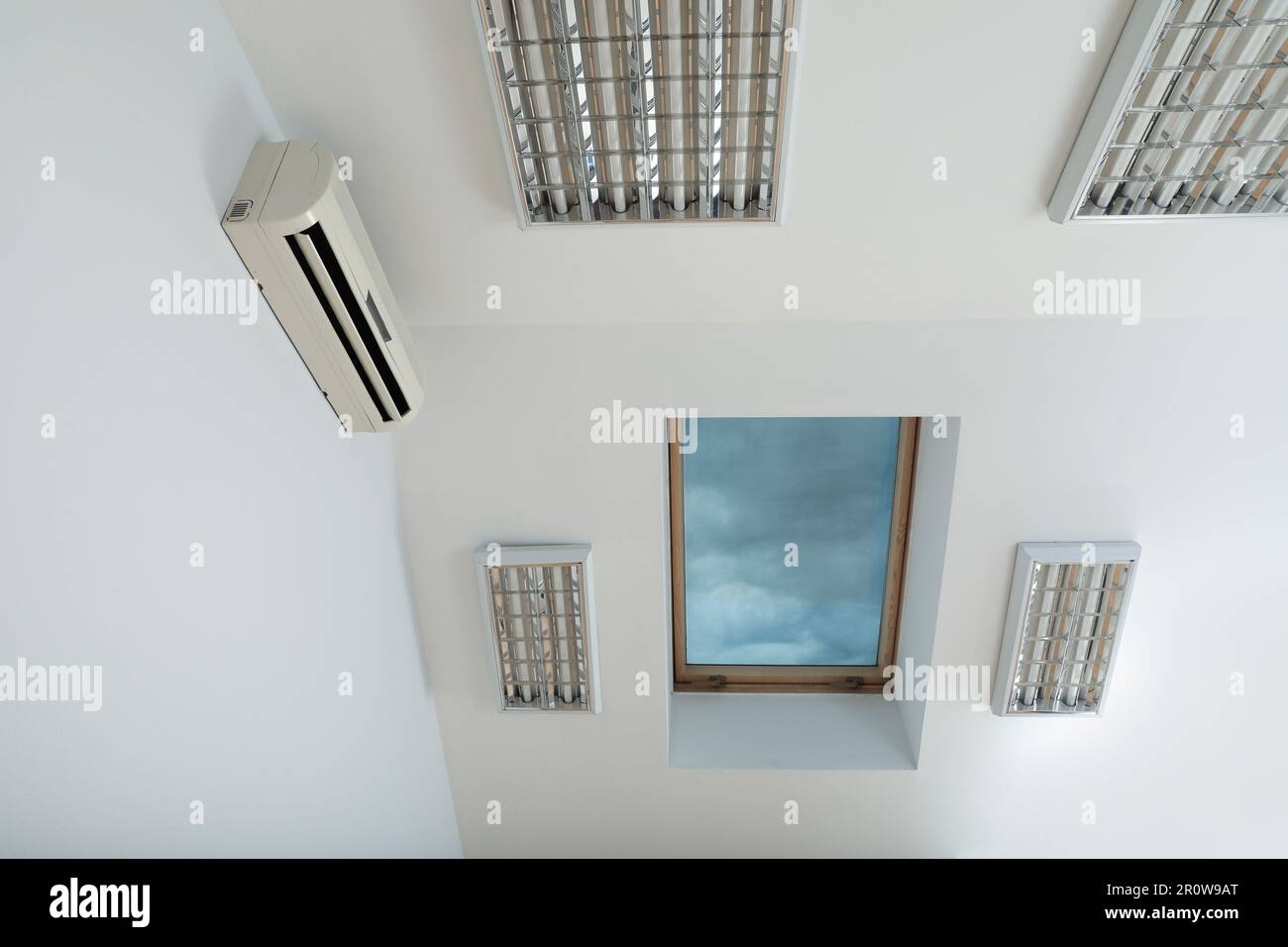 Modern air conditioner on white wall indoors Stock Photo - Alamy