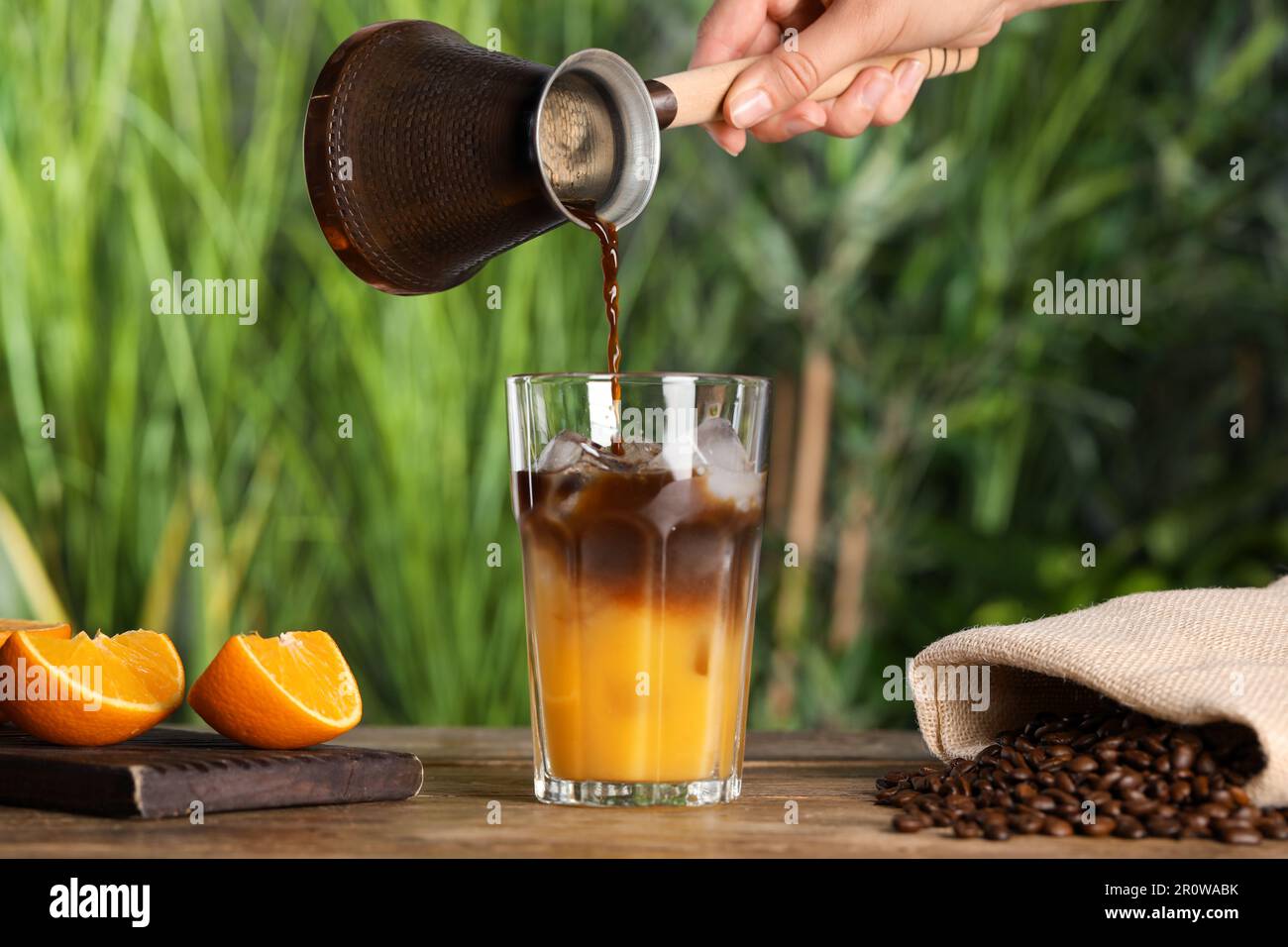 Ice cubes in tray and coffee beans on grey table, closeup Stock Photo -  Alamy