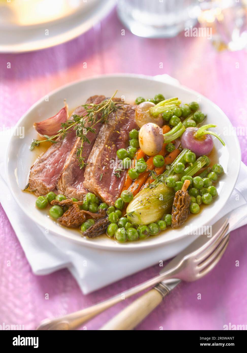 Beef fillet with morel gravy and spring vegetables Stock Photo