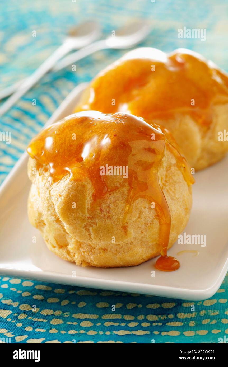 Cream puffs coated in caramel Stock Photo Alamy
