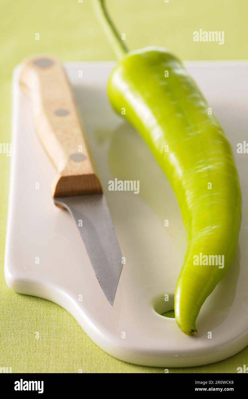 Green pepper on a chopping board Stock Photo - Alamy
