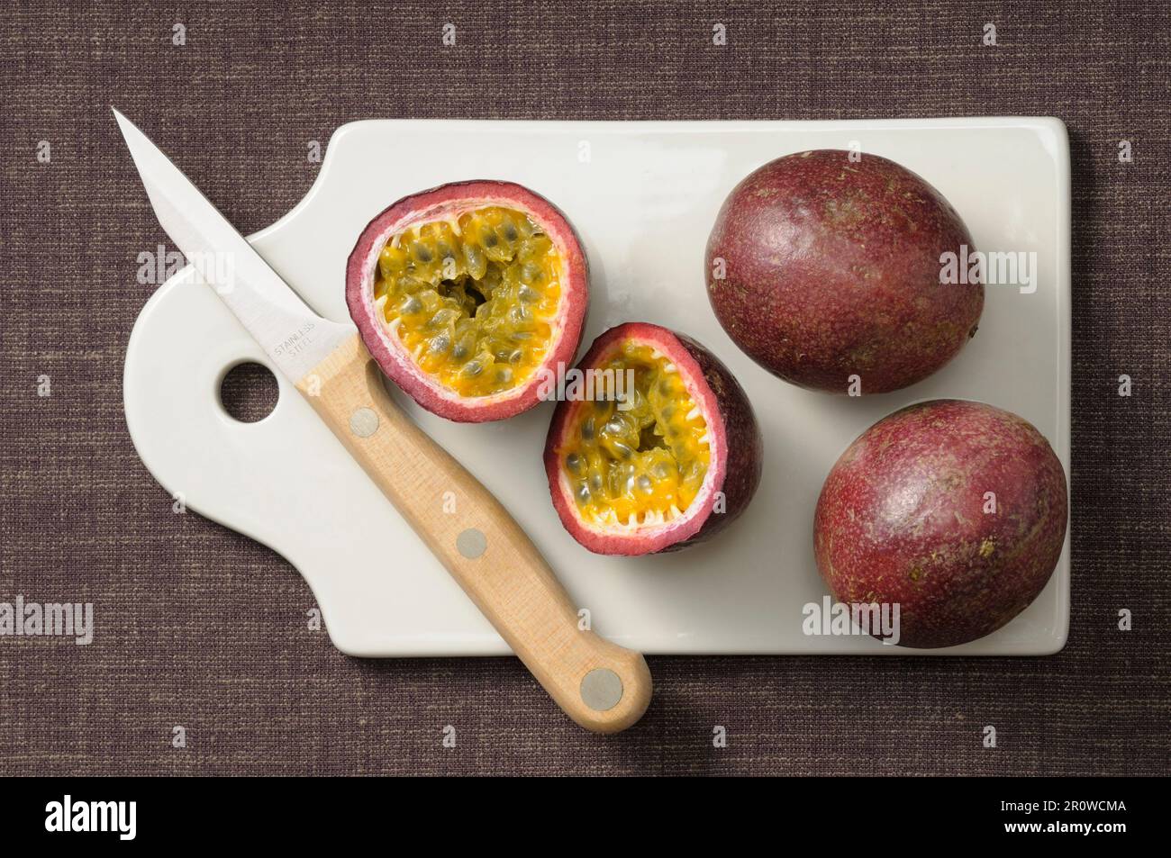 Passion fruits on a chopping board Stock Photo Alamy
